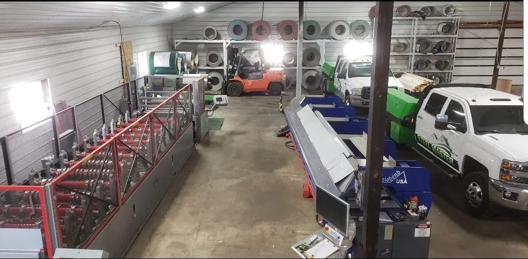 Metal fabrication equipment and roofing materials inside a Goshen, Indiana workshop